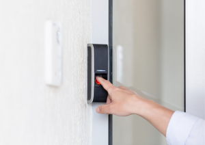 Picture of a hand about to press a video door bell
